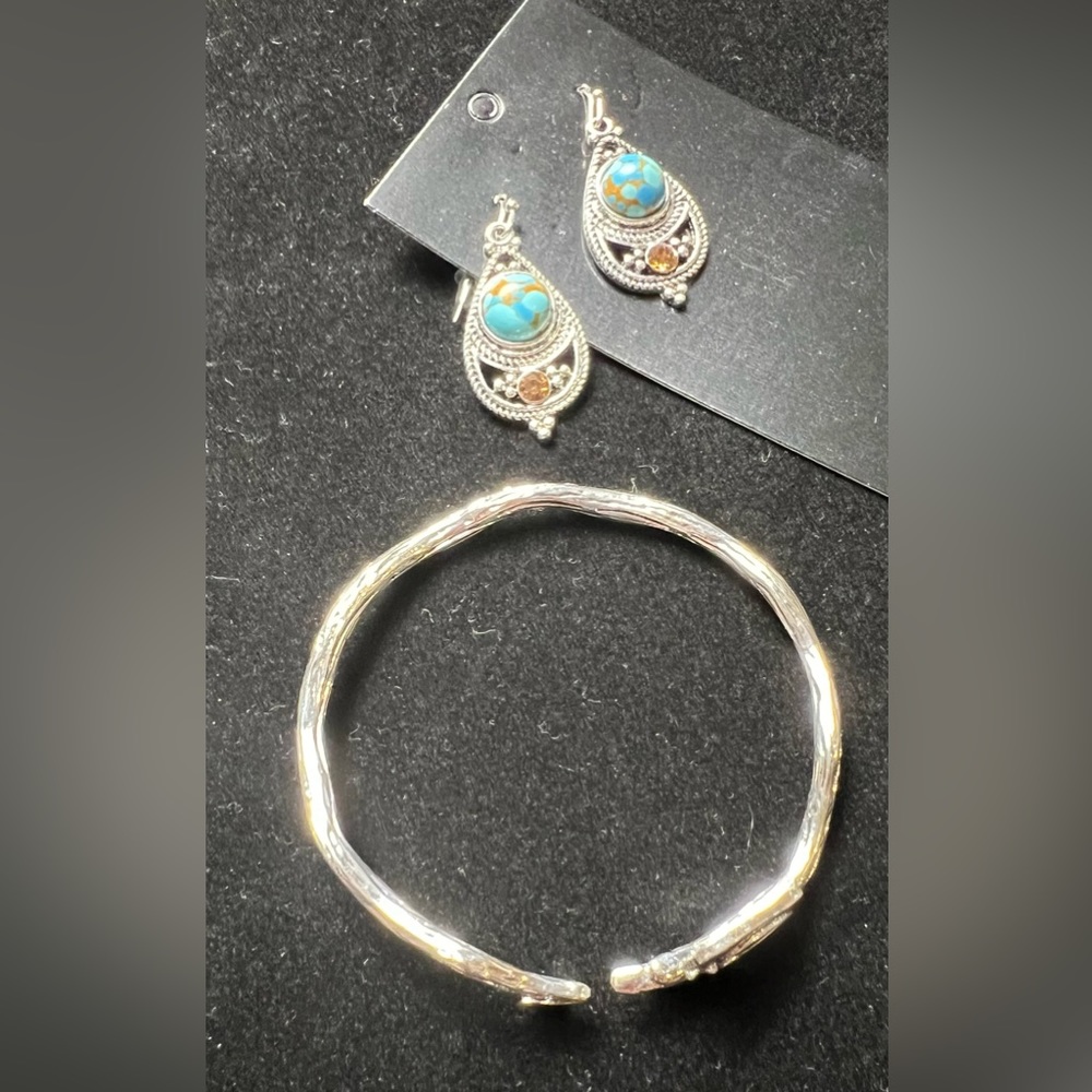 Turquoise colored silver fashion earrings and silver cuff bracelet.